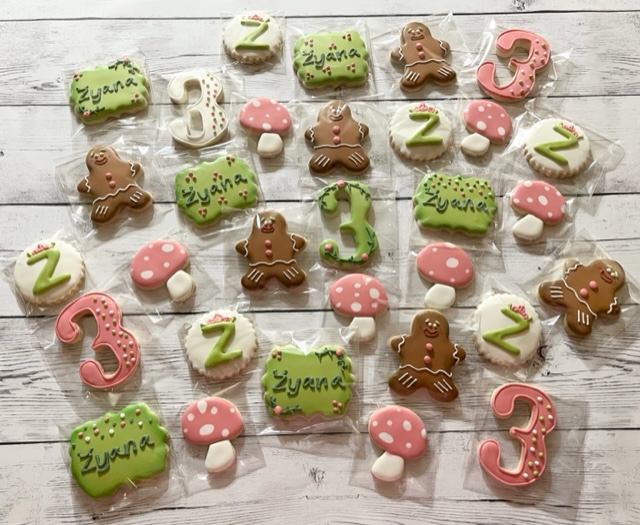 Cookies with a baby mushroom theme colored green and pink.