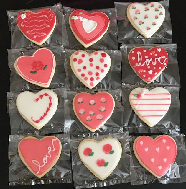 Valentines day theme cookie with red and pink heart design.