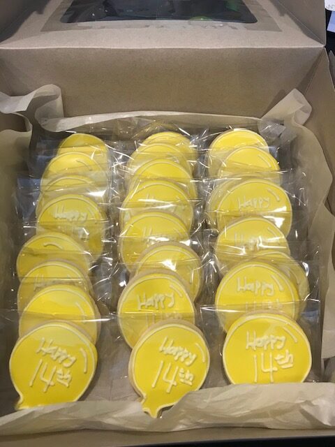 Holiday gift box-round yellow cookie with writing.