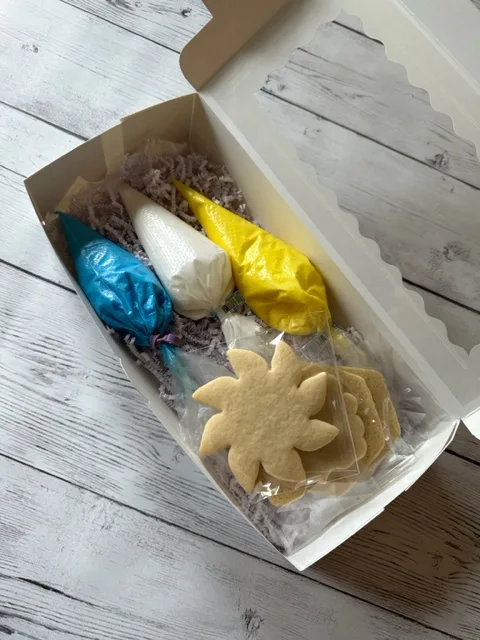 Do it yourself cookie decorating gift box. Yellow, white & blue colors. Lid open.