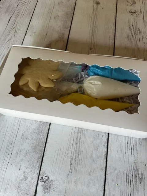 Do it yourself cookie decorating gift box. Yellow, white & blue colors. Lid closed.
